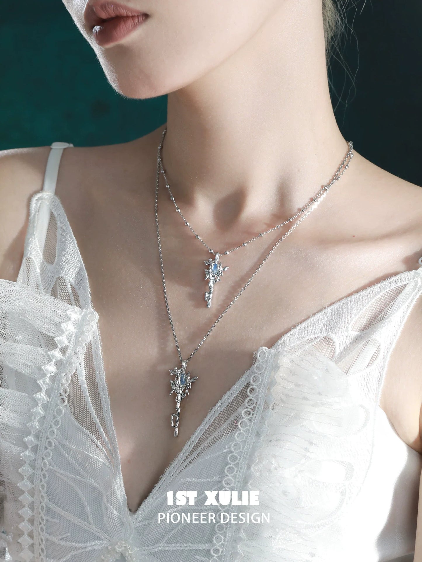 Elegant model wearing a silver mystic sprite necklace with intricate design and sparkling accents