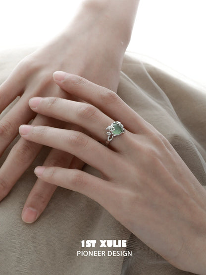 Mystical forest fairy silver ring with intricate design featuring a green gemstone
