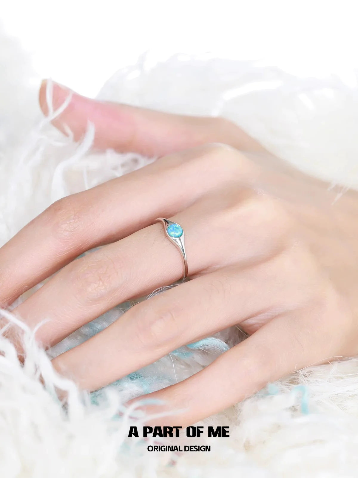 Elegant A PART OF ME opal color change ring featuring a stunning blue stone on a sleek band