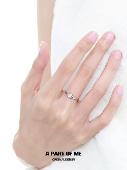 Stylish A PART OF ME opal color change ring on a hand showing its unique design and shimmer