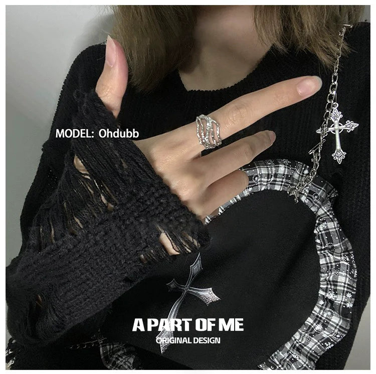 A PART OF ME bone minimalist ring shown on a hand wearing a black sweater with unique sleeve design