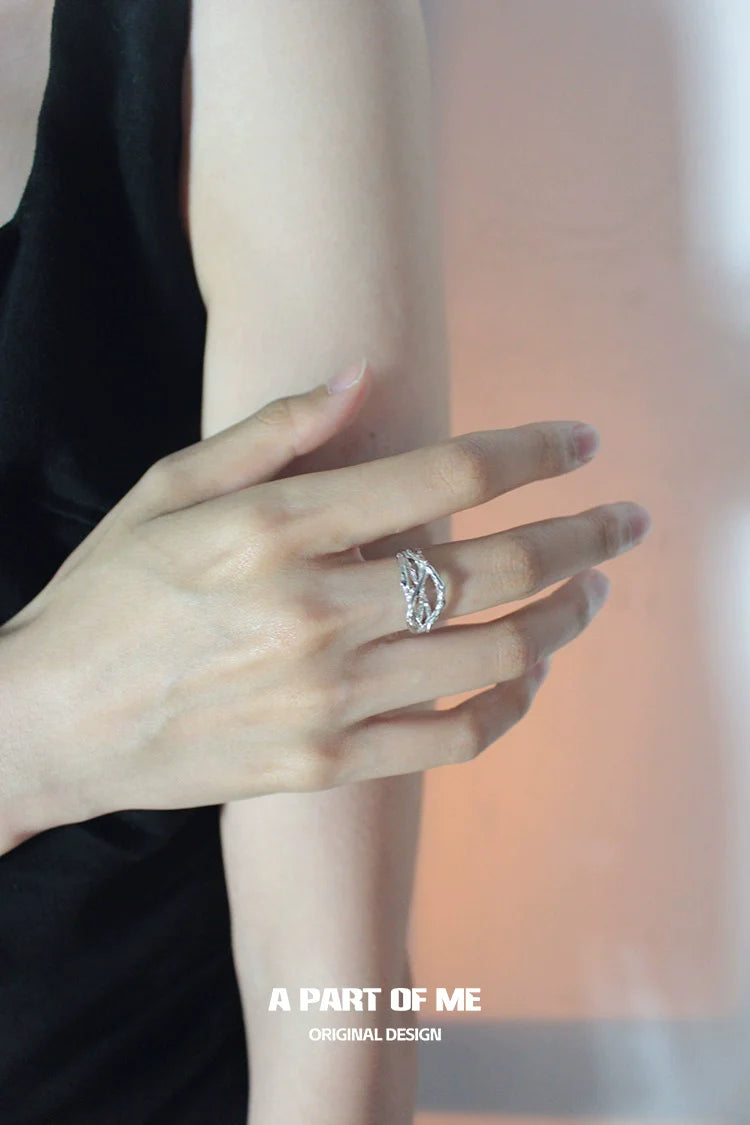 Irregular silver ring by A PART OF ME displayed on a hand for a stylish accessory look