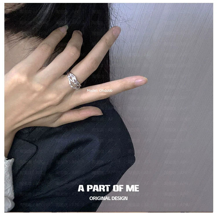 Irregular silver ring showcased on a hand in a stylish, minimalistic setting