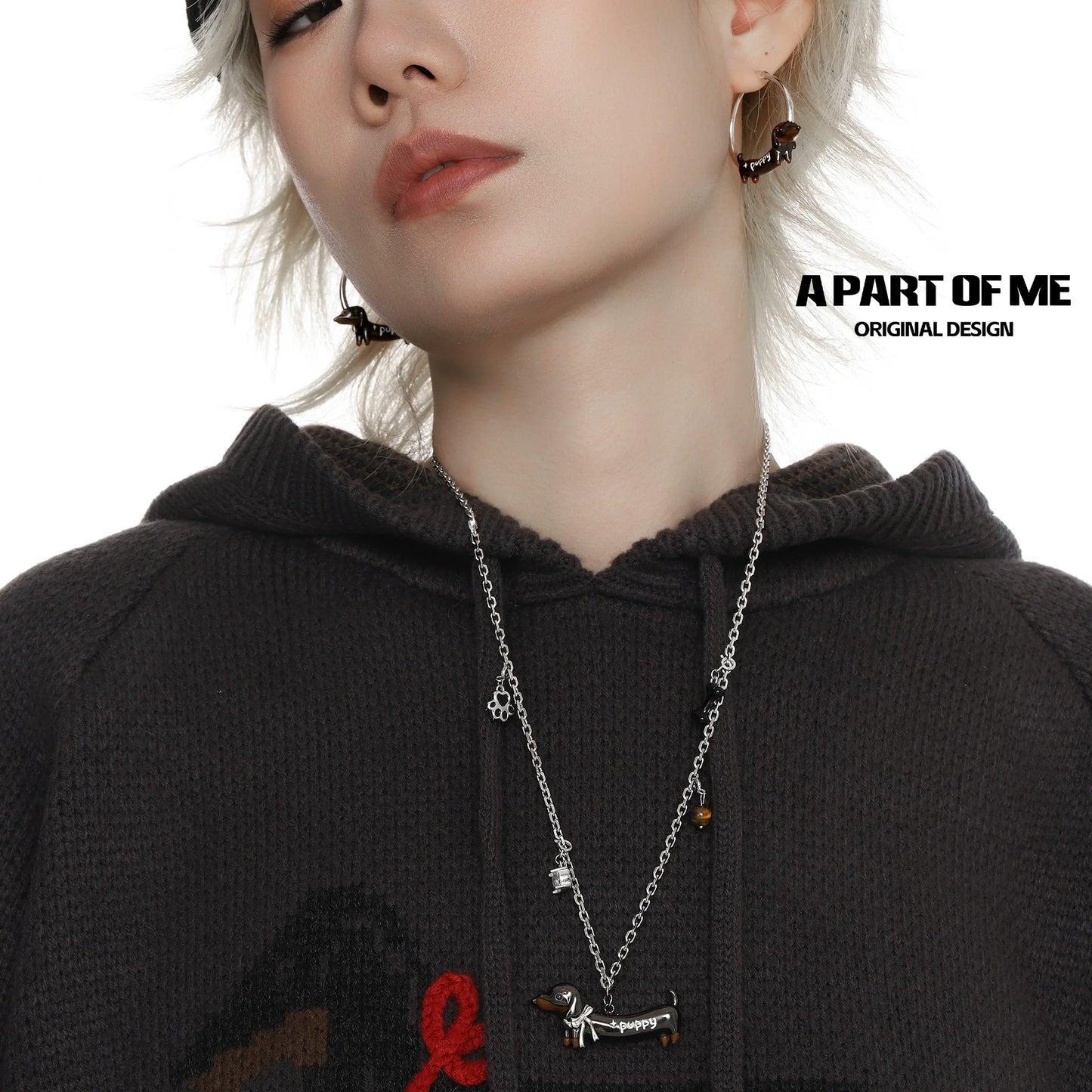 Stylish model wearing a lucky dachshund necklace with matching earrings from A PART OF ME