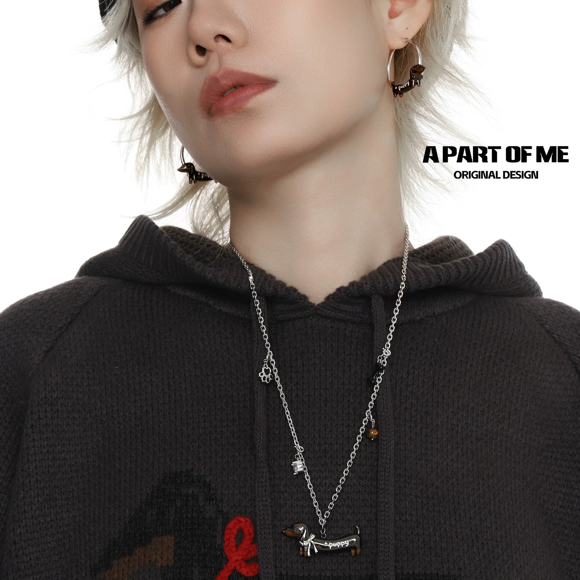 Stylish model wearing a lucky dachshund necklace with matching earrings from A PART OF ME