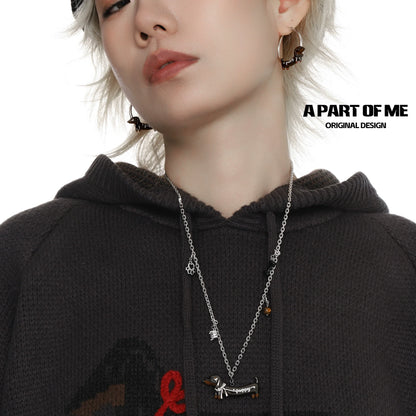 Stylish model wearing a lucky dachshund necklace with matching earrings from A PART OF ME