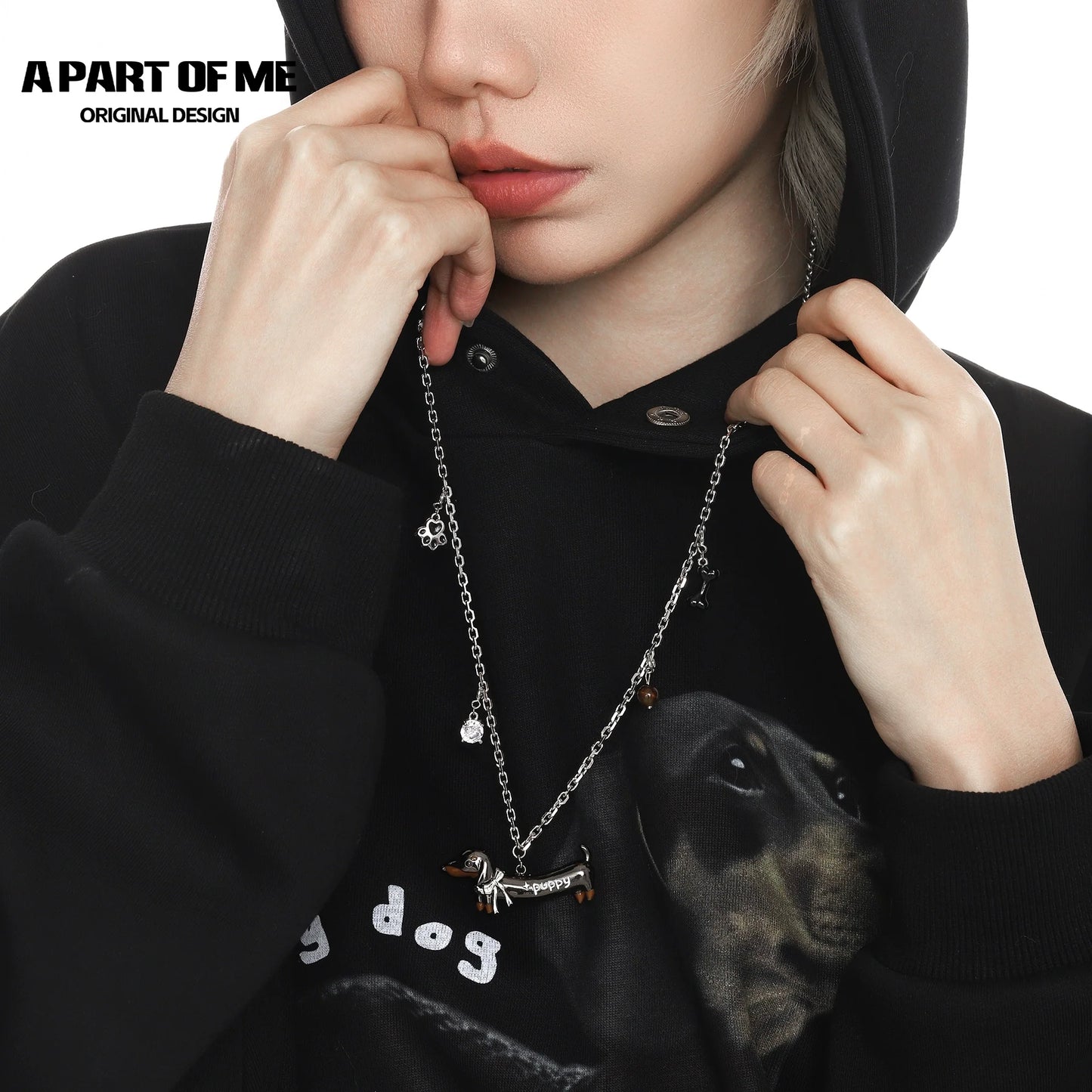 Lucky dachshund necklace displayed on a model wearing a black hoodie, showcasing its charm and design