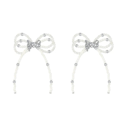 SUN HUNTER pearl bow ribbon earrings featuring elegant design with silver accents and delicate pearls