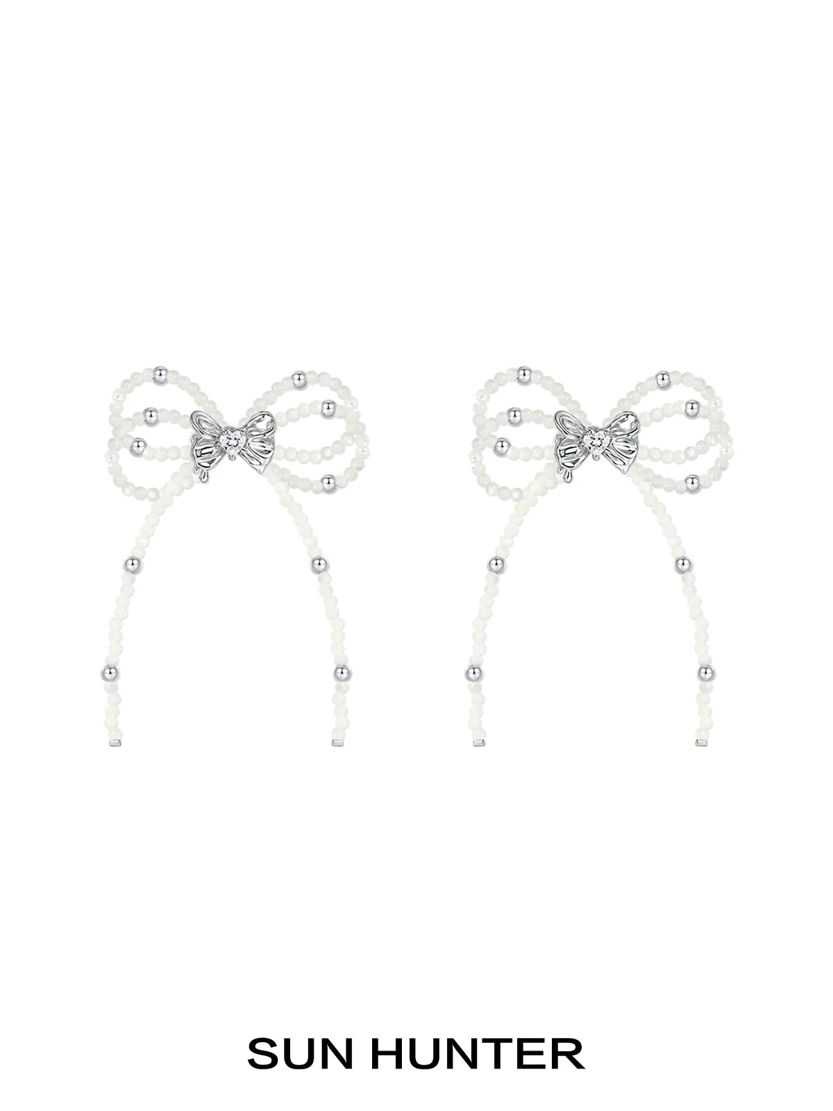 Elegant SUN HUNTER pearl bow ribbon earrings featuring sparkling accents for a stylish look