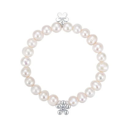 Elegant SUN HUNTER pearl bracelet for women featuring a silver flower charm and lustrous pearls