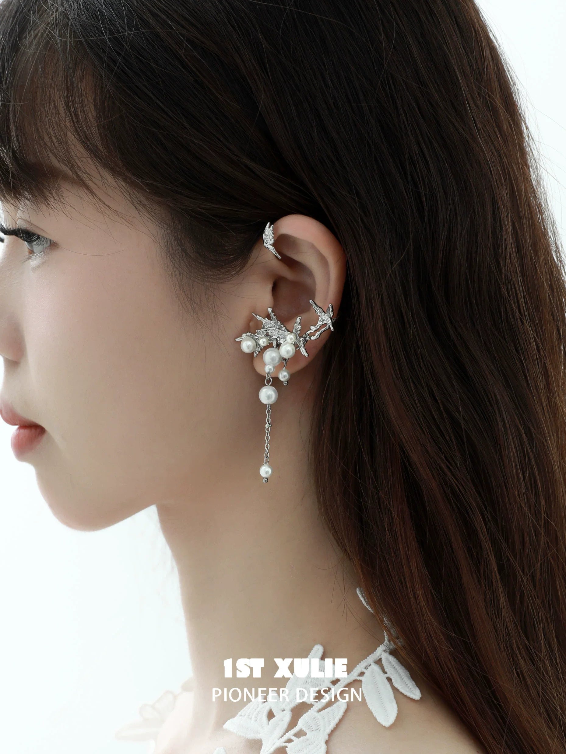 Elegant pearl butterfly ear cuffs featuring a delicate design with silver accents and dangling pearls