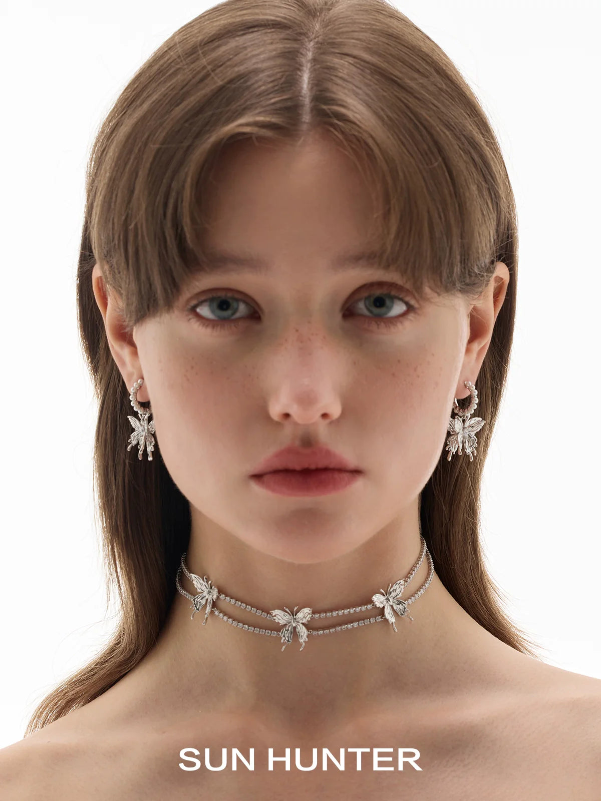 SUN HUNTER pearl butterfly earrings featured on a model for an elegant jewelry look