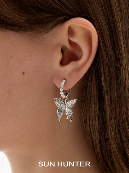 Silver pearl butterfly earrings featuring elegant design and classic charm for stylish accessorizing