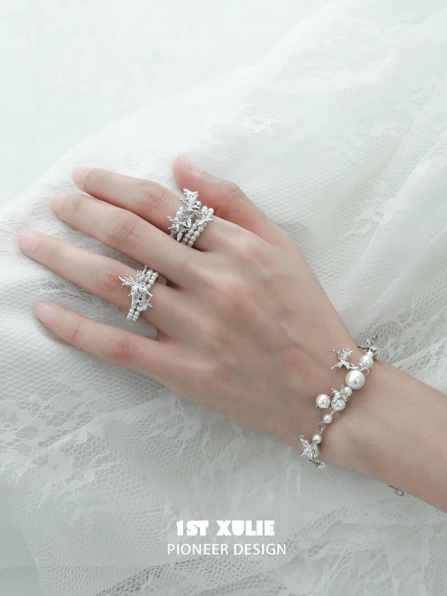 Elegant pearl butterfly ring displayed on a hand with matching jewelry for a stylish look