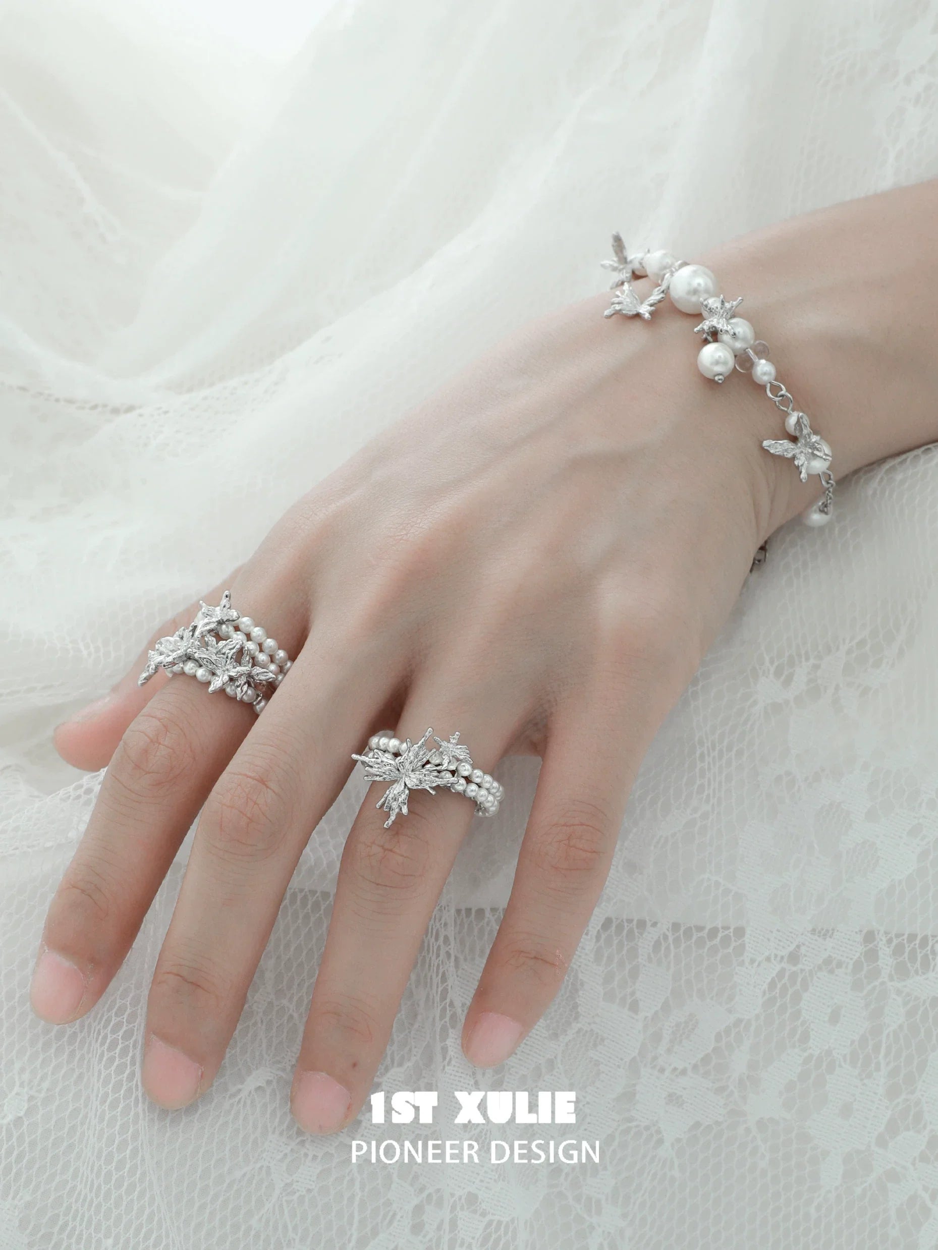 Elegant pearl butterfly ring showcased on a hand with matching pearl bracelet for a delicate look