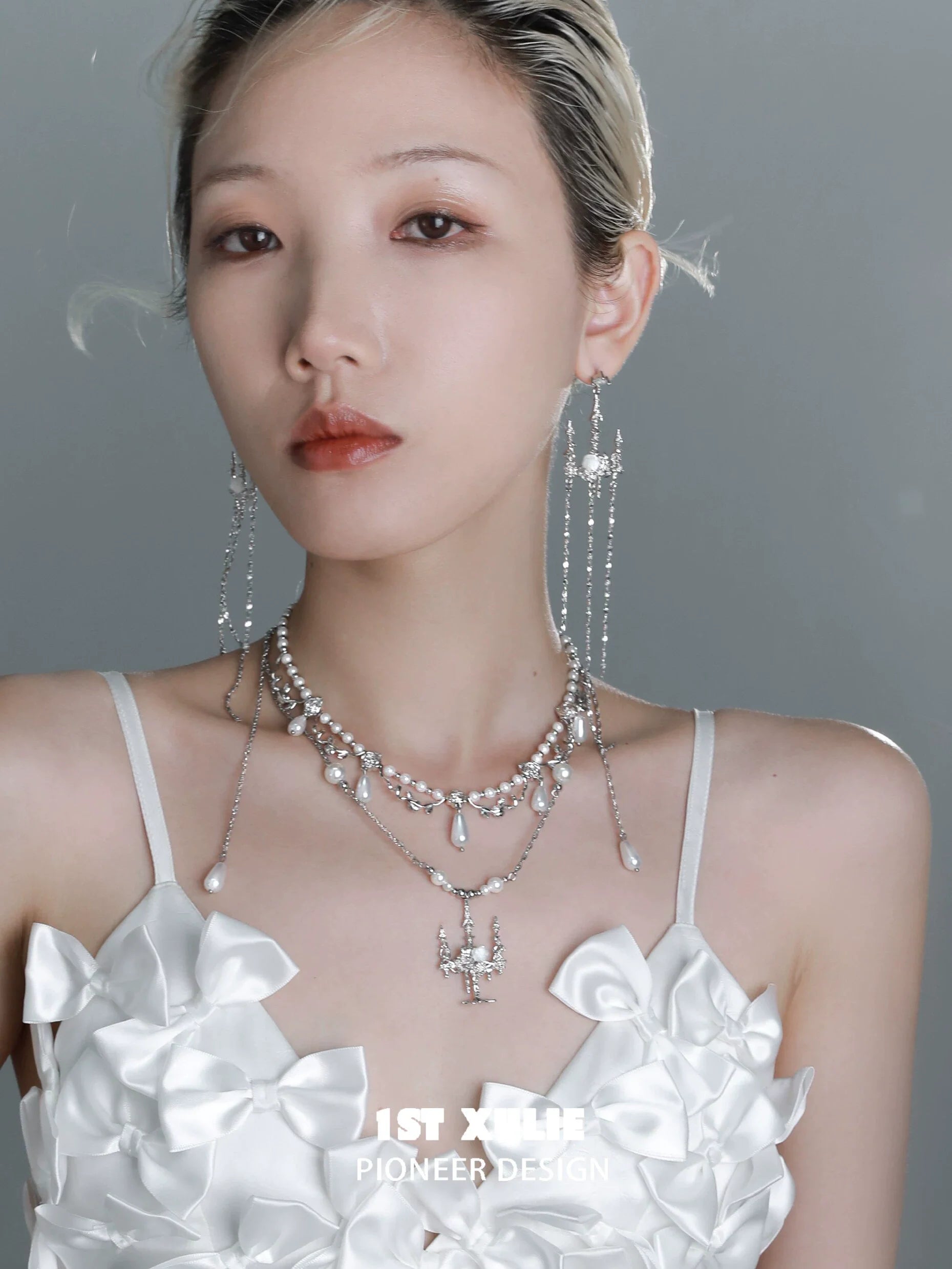Elegant pearl clavicle necklace layered with silver accents for a sophisticated look