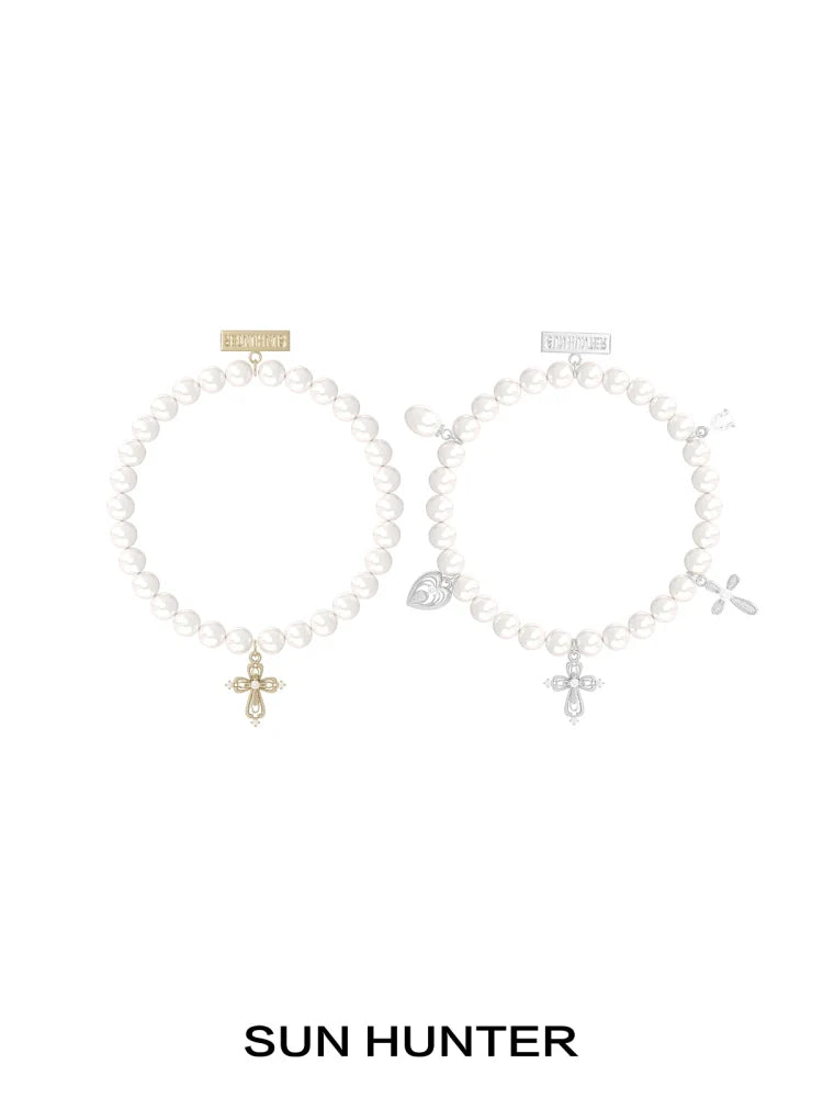 SUN HUNTER pearl cross bracelet featuring elegant pearls and a stylish cross charm