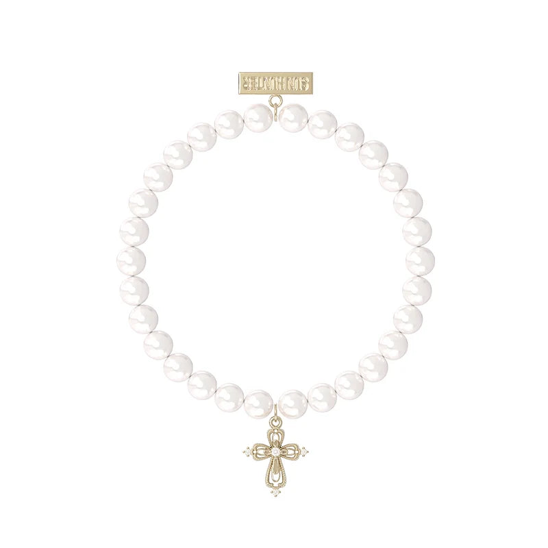 Elegant pearl cross bracelet featuring a delicate cross charm and shiny white pearls
