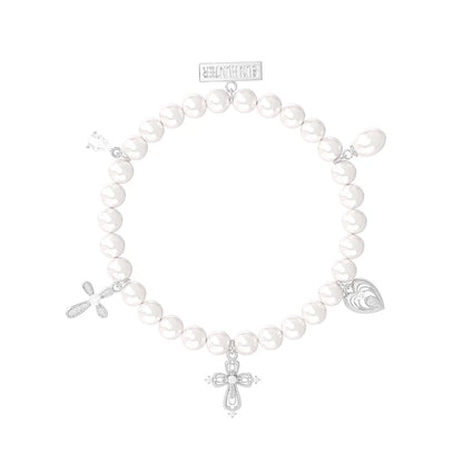 Elegant pearl cross bracelet featuring silver charms for a stylish accessory look