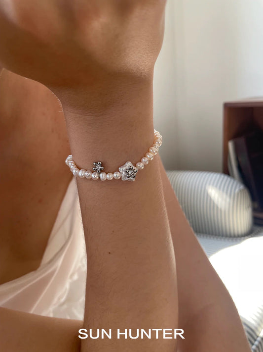 Elegant pearl star bracelet by SUN HUNTER featuring lustrous pearls and star accents