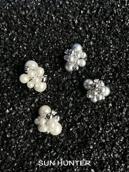 Elegant SUN HUNTER pearl zircon statement earrings featuring clusters of white and silver pearls