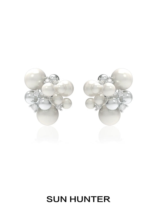 SUN HUNTER pearl zircon statement earrings featuring a cluster design with lustrous pearls and sparkling zircon.