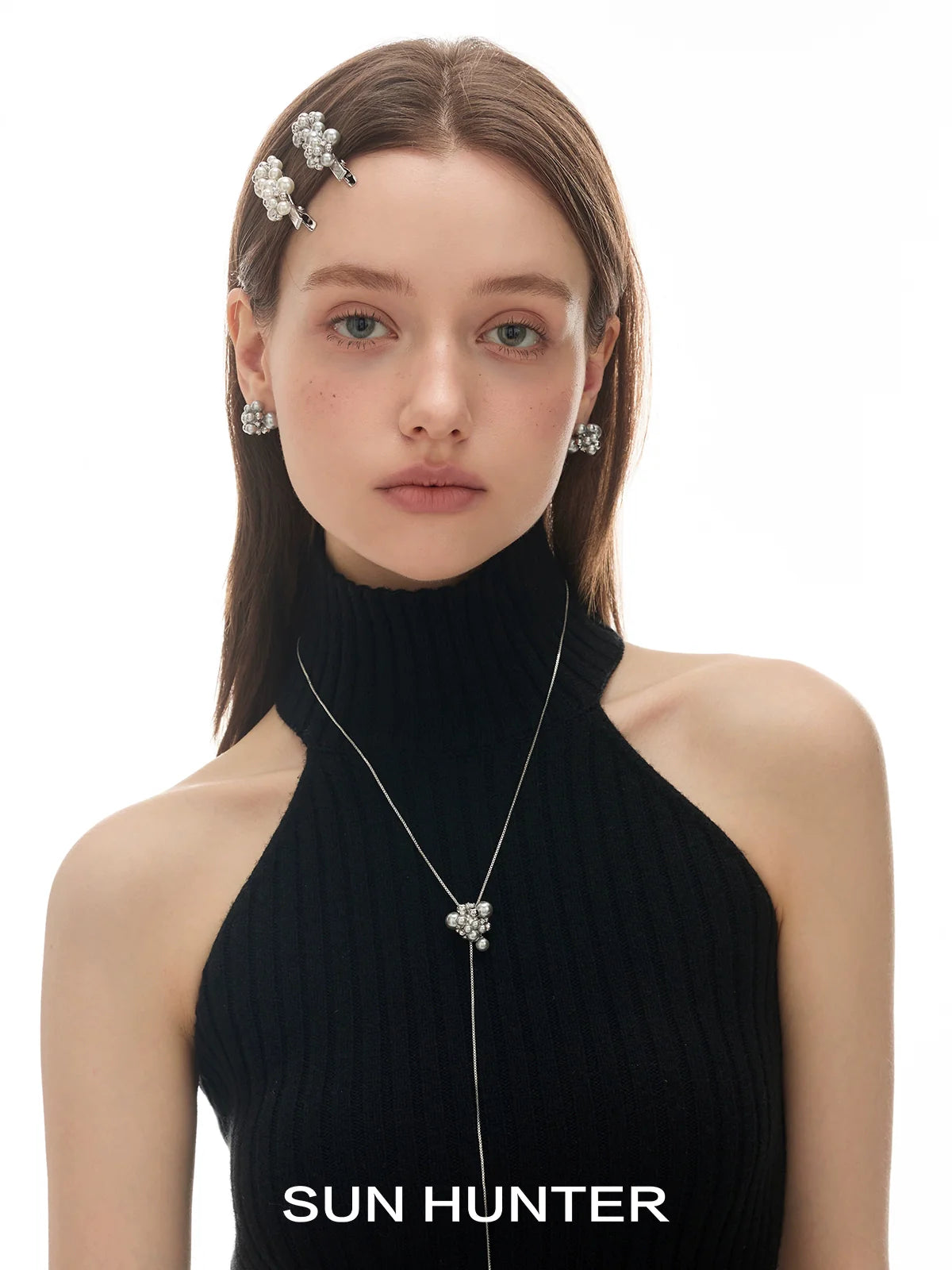 Model wearing pearl zircon statement earrings paired with stylish accessories from SUN HUNTER