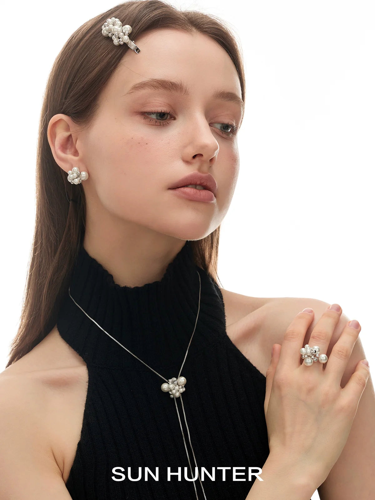 Elegant model wearing pearl zircon statement earrings with matching jewelry by SUN HUNTER