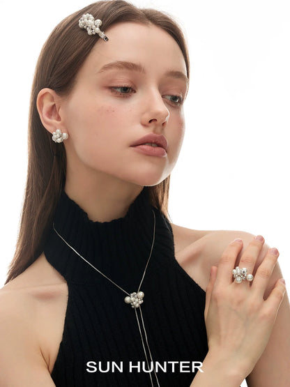 Elegant model wearing pearl zircon statement earrings with matching jewelry by SUN HUNTER
