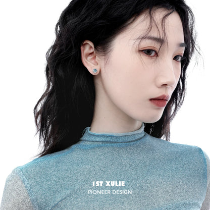Model showcasing aqua gemstone stud earrings in a stylish setting for elegant fashion lovers