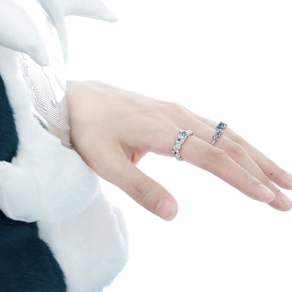 Elegant aurora glacier silver ring worn on a hand, showcasing sparkling gemstones and intricate design