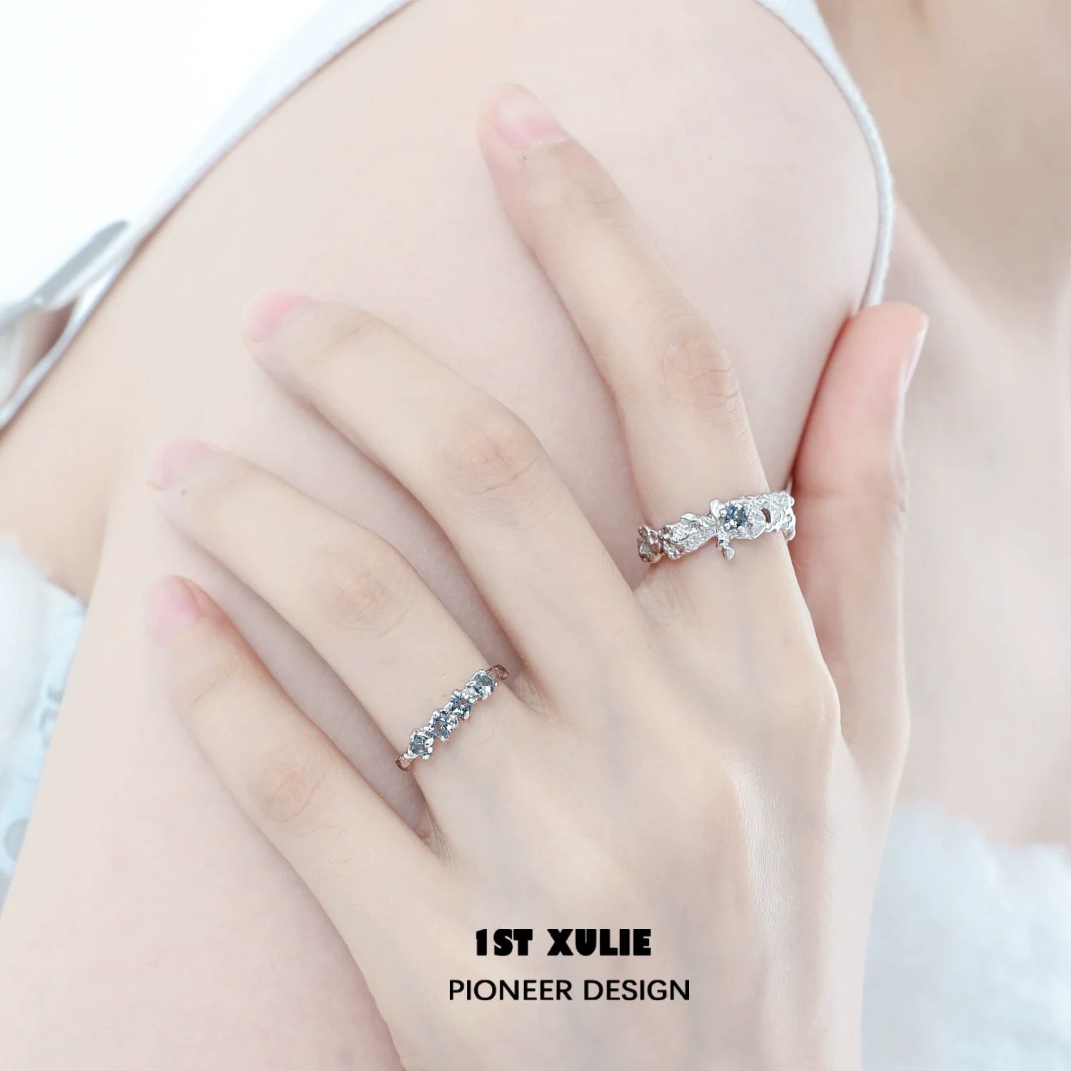 Elegant aurora glacier silver ring displayed on a model's hand alongside a matching ring