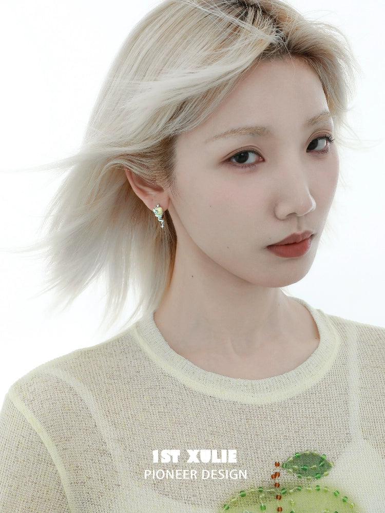Beautiful woman wearing forbidden apple snake ear clip showcasing a unique and trendy design
