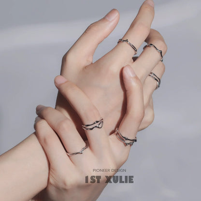 Minimalist silver line art ring showcased on multiple fingers for a stylish look