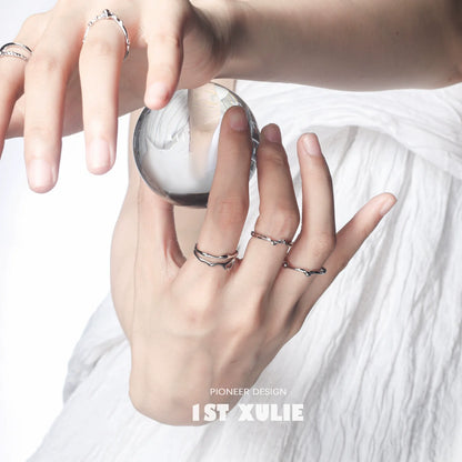 Elegant minimalist silver line art ring displayed on hand holding a crystal ball
