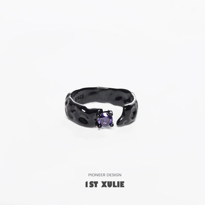 Y2K gothic couple rings featuring a unique textured design and violet gemstone centerpiece