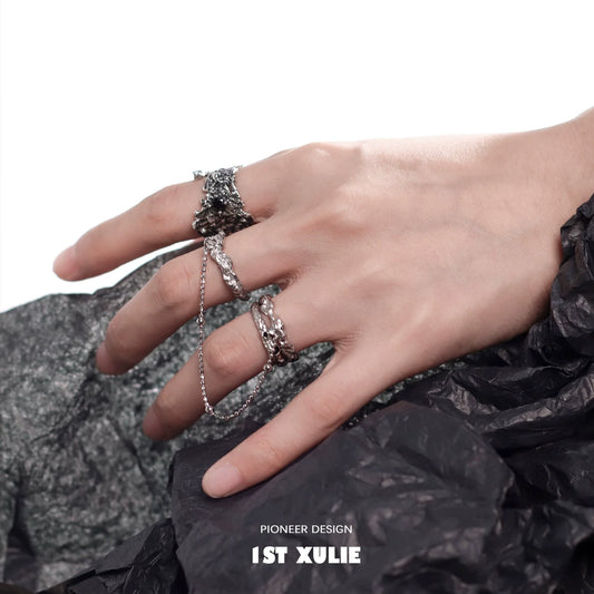 Stylish Y2K meteorite ring worn on a hand with unique design and textured background