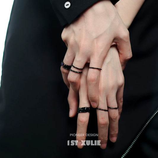 Stylish Y2K silver ring collection showcased on hands with black and silver detailing