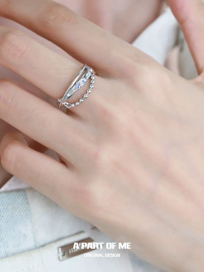A PART OF ME planet chain ring with a silver finish, featuring delicate diamond-like accents on a hand model