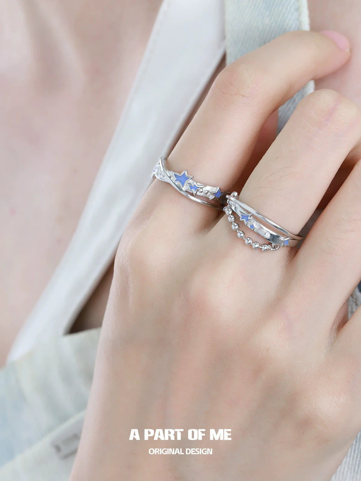 A PART OF ME planet chain ring showcased on a model's hand with stylish stars and elegant design