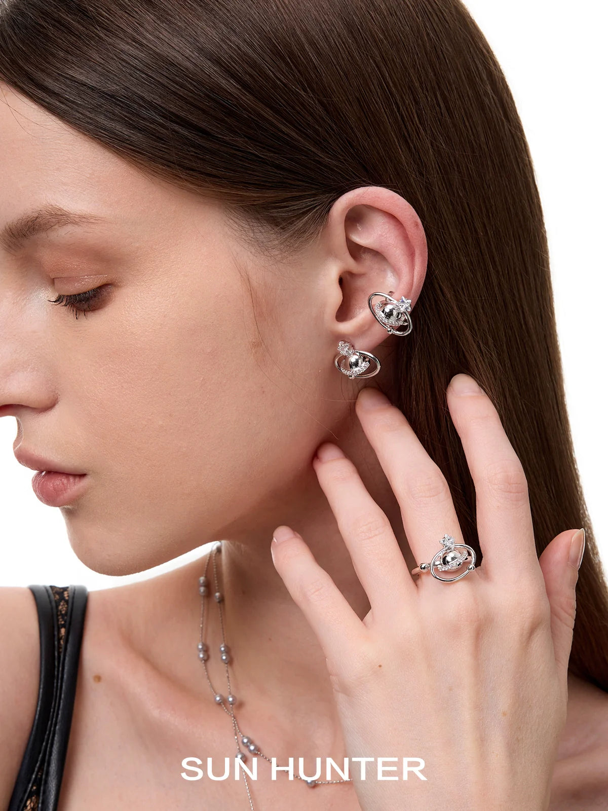 Model wearing SUN HUNTER planet garden ring alongside matching ear accessories