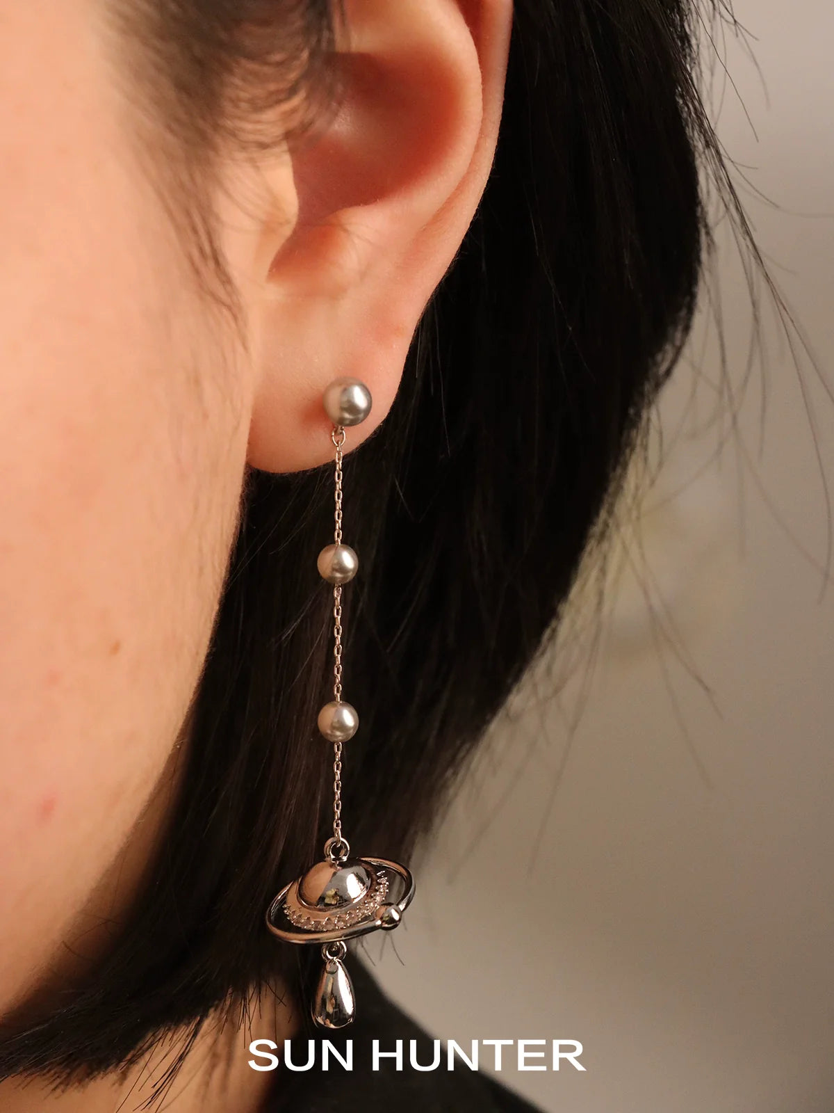 SUN HUNTER planet pearl drop earrings featuring a unique design with shimmering planets
