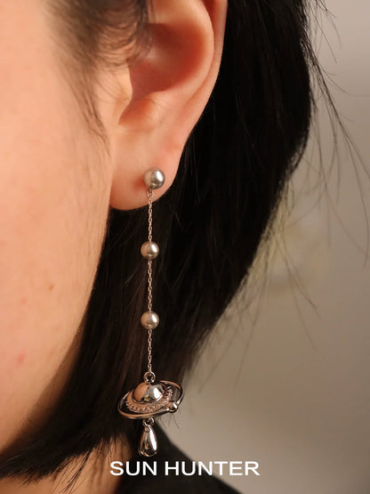 SUN HUNTER planet pearl drop earrings featuring a unique design with shimmering planets