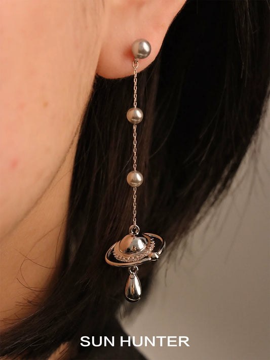 SUN HUNTER planet pearl drop earrings featuring a Saturn charm and elegant gray pearls
