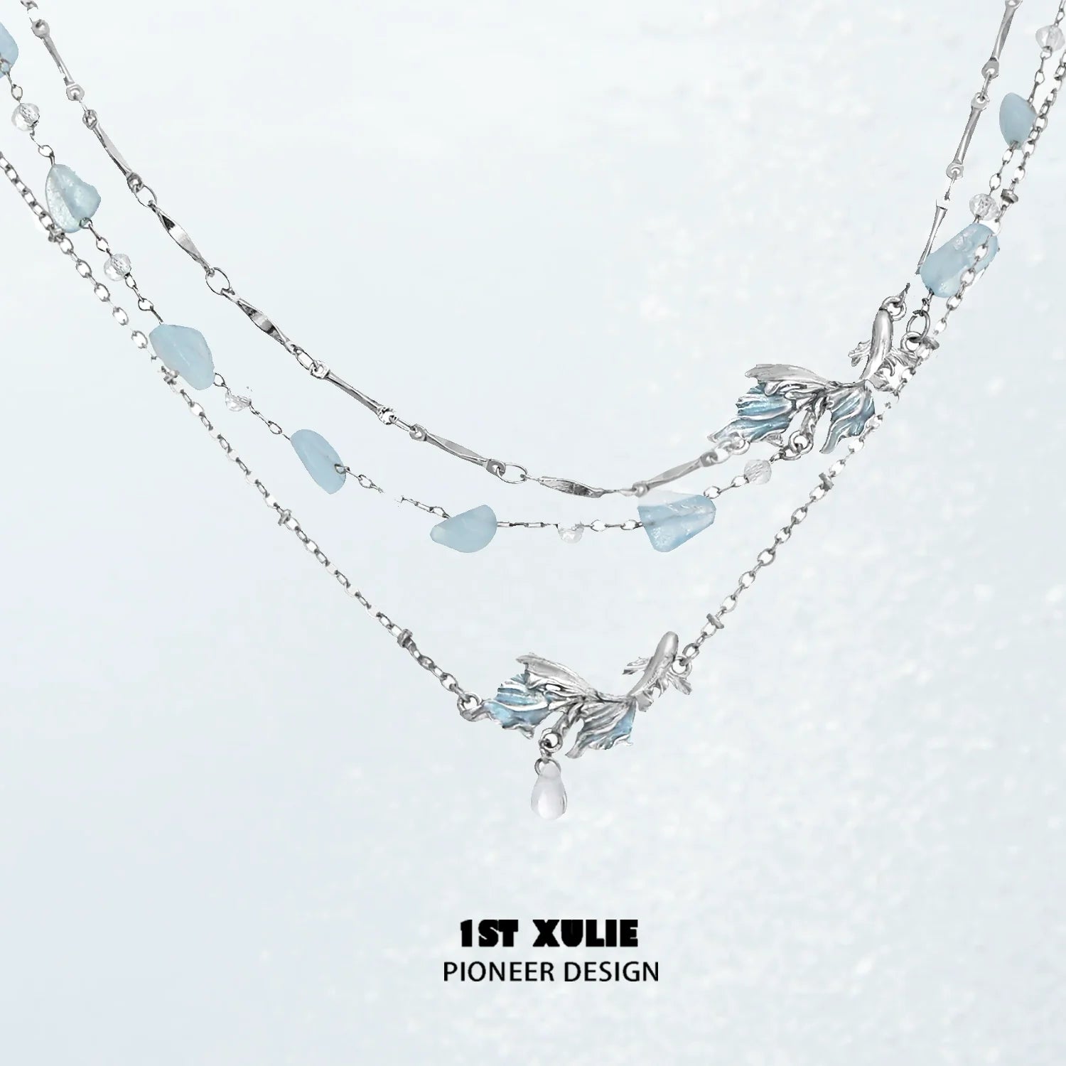 Playful fish necklace with silver chain and aqua-colored accents for a charming look