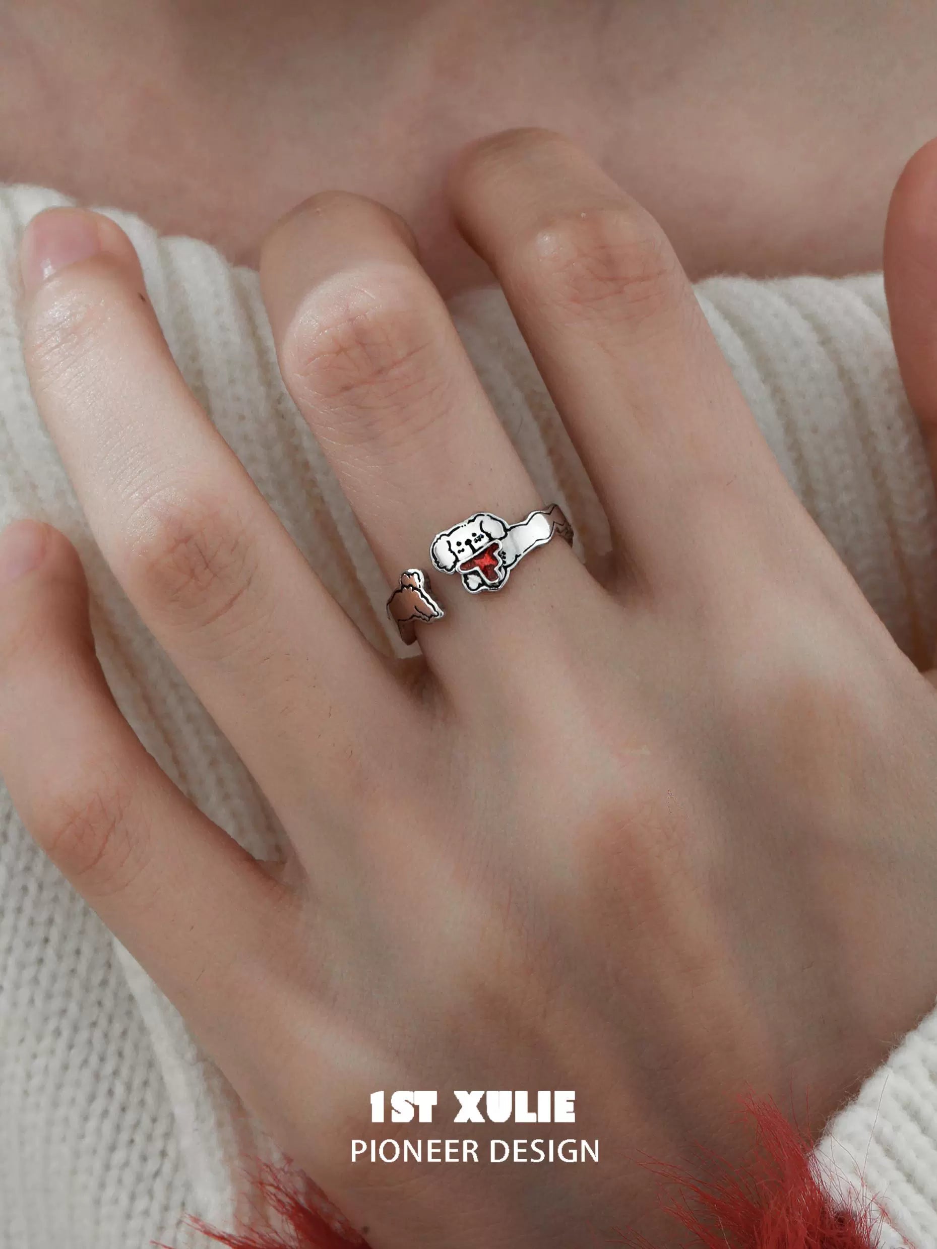 Playful puppy silver ring by 1STXULIE showcased on a hand with a cozy sweater