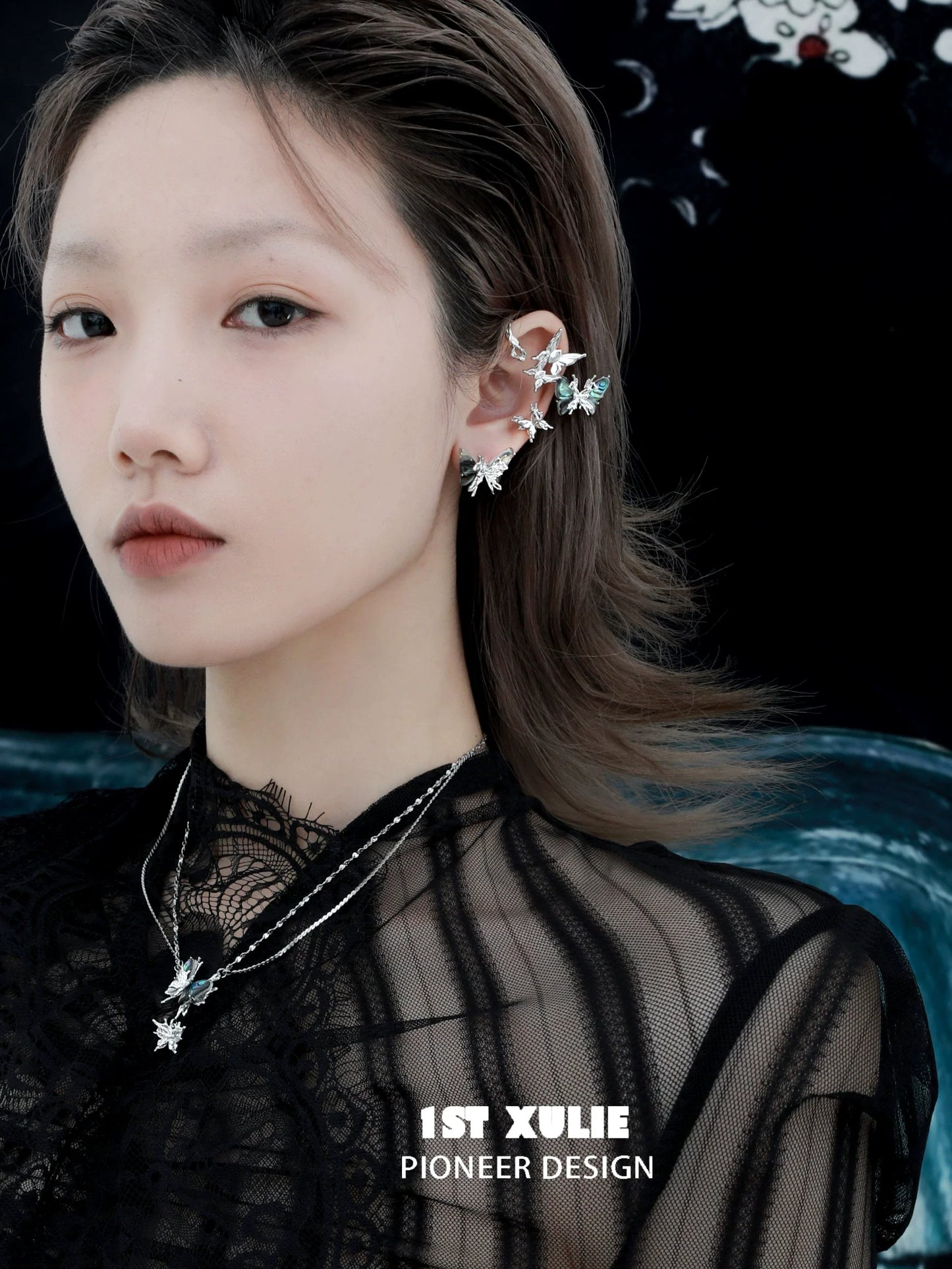 Model wearing punk butterfly ear clips in silver with intricate design and sparkling details