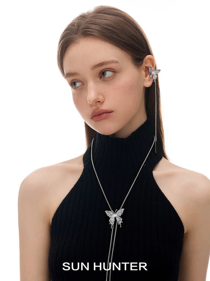 Model wearing SUN HUNTER punk butterfly ear cuffs with a stylish black top and sleek hairstyle