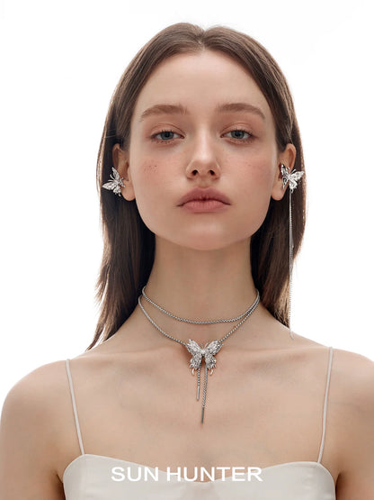 Model wearing SUN HUNTER punk butterfly ear cuffs with matching butterfly necklace for a stylish look