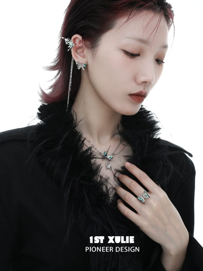 Punk butterfly earrings displayed on a model with a stylish outfit and layered accessories